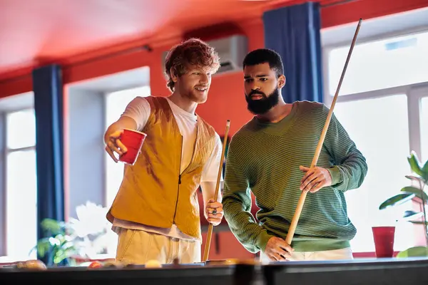 Friends are playing billiards together in a casual setting. — Stock Photo