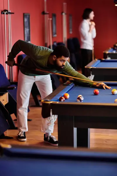 Friends enjoy a relaxed game of billiards in a stylish setting. — Stock Photo