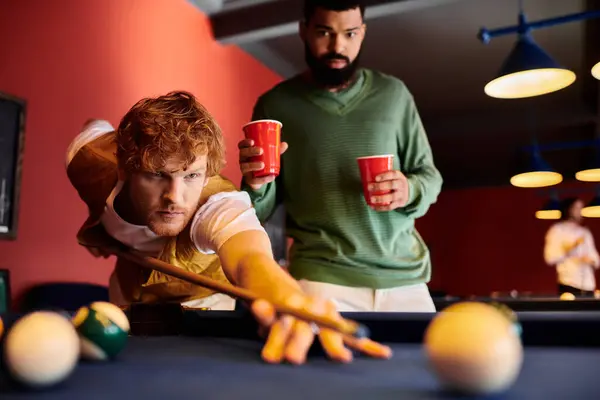 Friends enjoy a game of billiards at a casual establishment. — Stock Photo