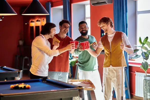Friends celebrate after a game of billiards, enjoying drinks and snacks. — Stock Photo