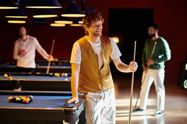 Friends enjoy a casual game of billiards in a dimly lit pool hall. — Stock Photo