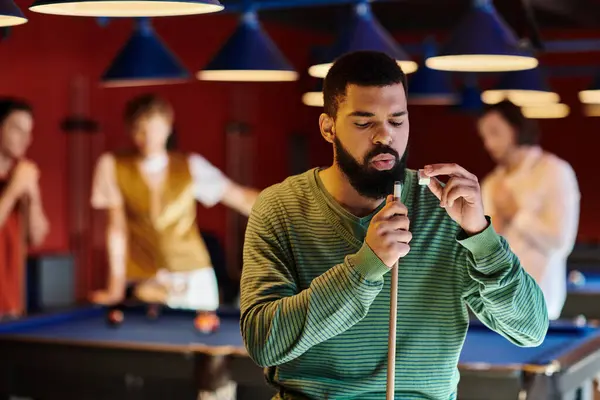A man prepares to take a shot in a game of billiards. — Stock Photo