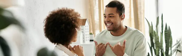 A couple communicates using sign language in their home. — Stock Photo
