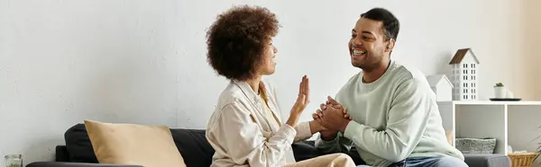 A loving couple using sign language to communicate at home. — Stock Photo