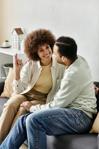 An affectionate African American couple communicates through sign language while relaxing at home. — Stock Photo