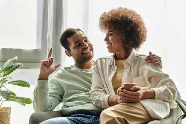 An African American couple uses sign language to communicate at home, showcasing a deep connection and understanding. — Stock Photo