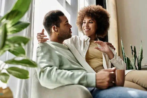 A loving African American couple communicates through sign language in their home. — Stock Photo