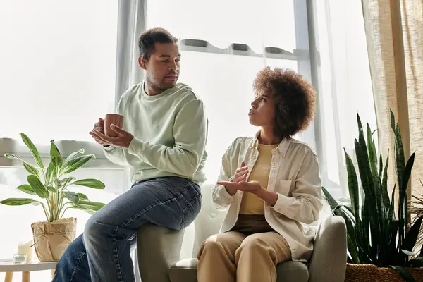 A young African American couple talks with sign language at home. — Stock Photo