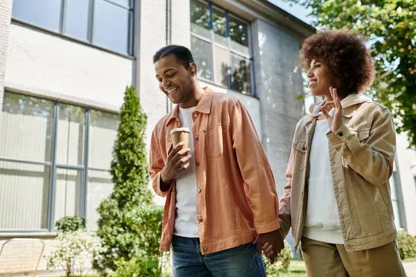 A happy African American couple walks hand-in-hand, communicating through sign language. — Stock Photo