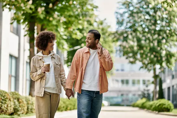 A happy African American couple walks hand-in-hand, using sign language to communicate. — Stock Photo