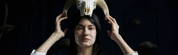 A woman with painted face and a skull crown stares intently at the camera. — Stock Photo