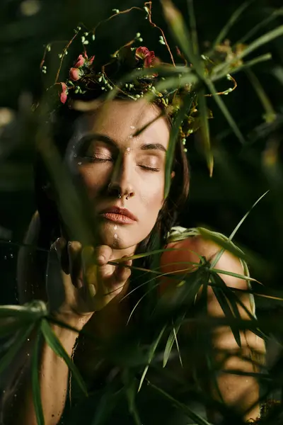 A woman with a flower crown stands in a swamp, eyes closed, surrounded by lush greenery. — Stock Photo