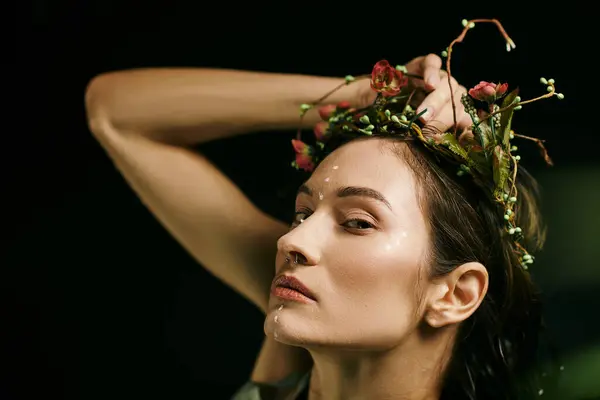 An attractive woman with a floral crown poses in a swampy setting. — Stock Photo