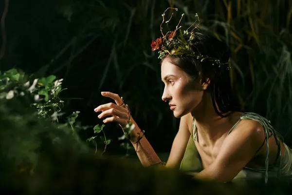 A woman in a floral crown reaches out towards a swamp, surrounded by greenery. — Stock Photo