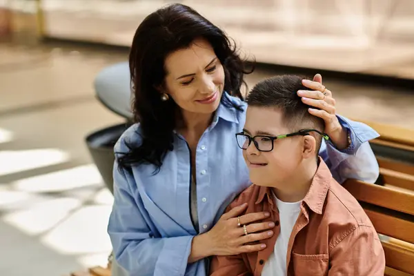 A mother and her son with Down syndrome share a tender moment while out shopping. — Stock Photo
