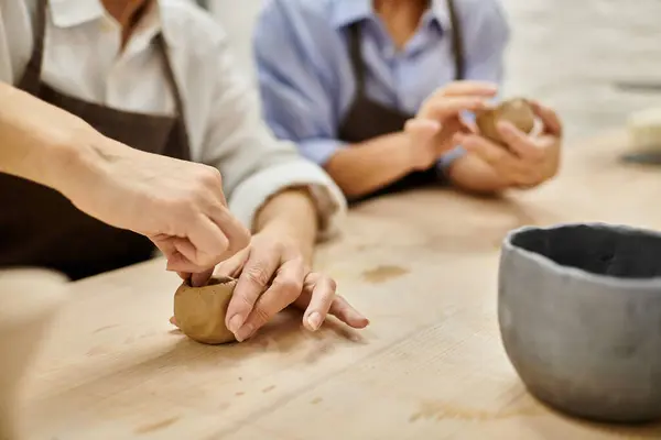 Two women in an art studio, crafting pottery together. — Stock Photo