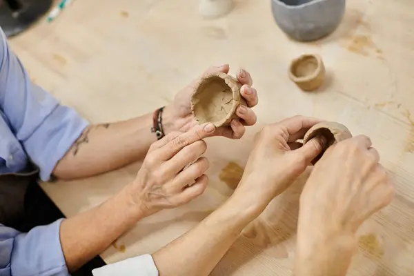 A lesbian couple creates pottery together in a cozy art studio. — Stock Photo