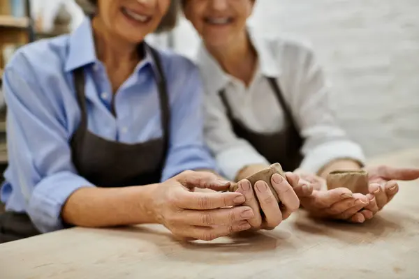 Two women in an art studio working with clay. — Stock Photo