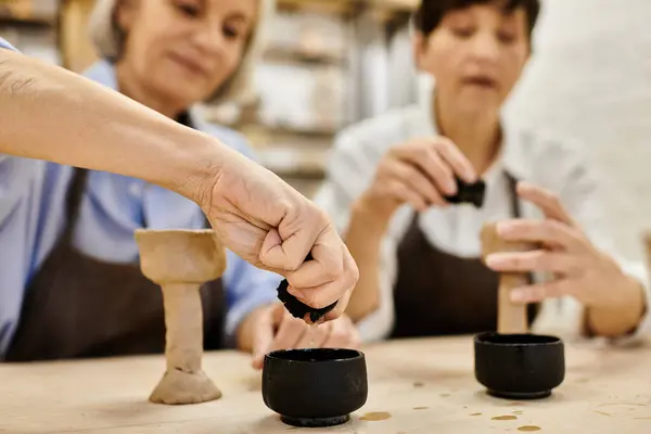 Two women craft pottery together in a cozy studio setting. — Stock Photo