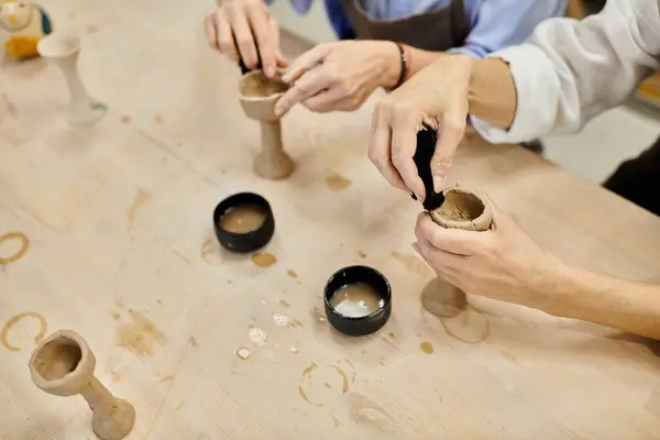 Two women work on their pottery in a cozy studio setting. — Stock Photo