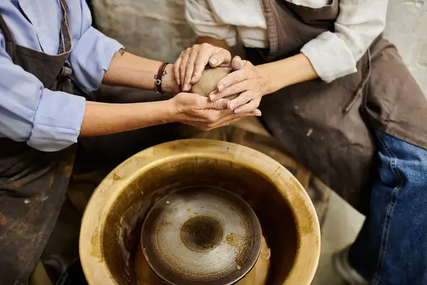 A lesbian couple works together on a pottery project in a cozy art studio. — Stock Photo