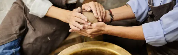 A mature lesbian couple crafts pottery together in a cozy art studio. — Stock Photo