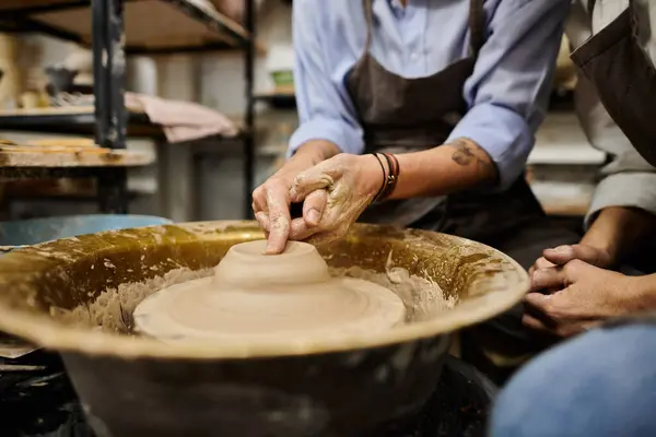 A couple works on pottery in a studio setting. — Stock Photo