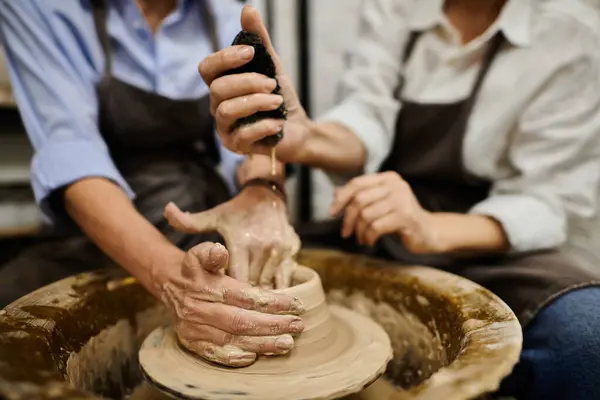 A lesbian couple working together in a pottery studio. — Stock Photo