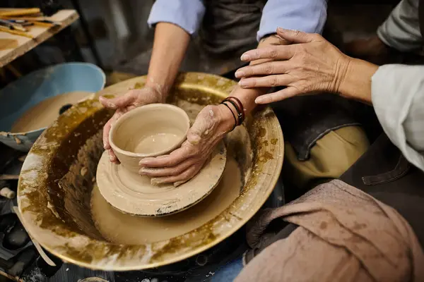 A close-up of a mature lesbian couple working on pottery in a cozy studio setting. — Stock Photo