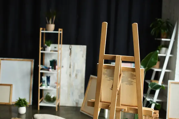 A wooden easel stands in the middle of an artists workshop, ready for a new creation. — Stock Photo