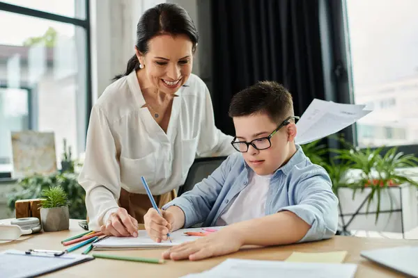 Une mère et son fils, atteints du syndrome de Down, travaillent ensemble dans un bureau à domicile, faisant preuve d'inclusivité et de diversité.. — Photo de stock