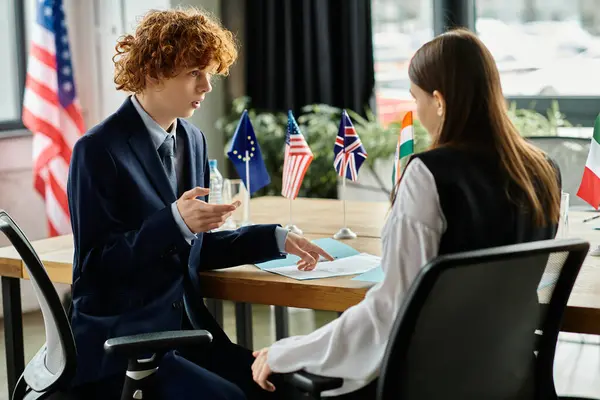 Two teenagers participate in a Model United Nations simulation, representing different countries. — Stock Photo