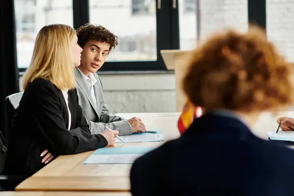 Two teenagers participate in a UN Model session, discussing a resolution. — Stock Photo