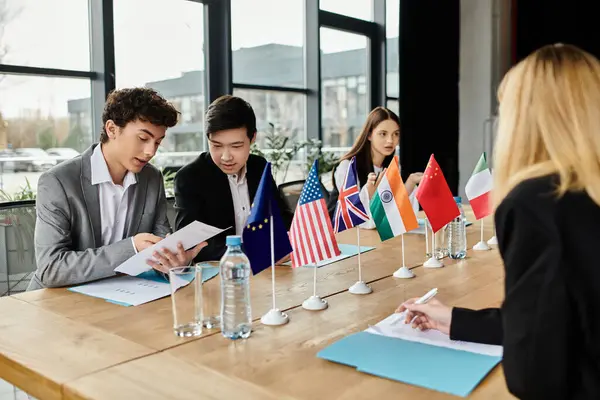 Young delegates participate in a Model UN simulation, representing different countries. — Stock Photo