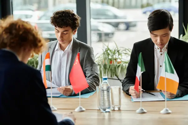 Two teenagers participate in a Model UN simulation, representing different countries. — Stock Photo
