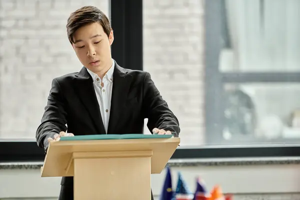 Teenage boy in a suit delivers a speech at a UN Model conference. — Stock Photo