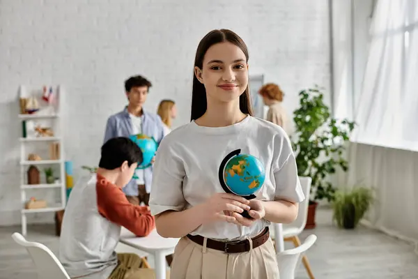 A teenager holds a globe during a UN Model session. — Stock Photo