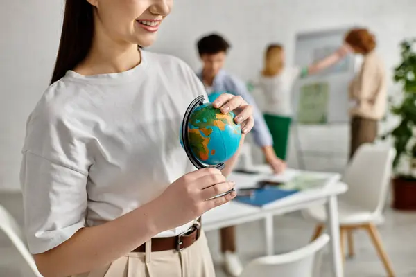 Teenage girl holds a globe during a UN Model conference. — Stock Photo
