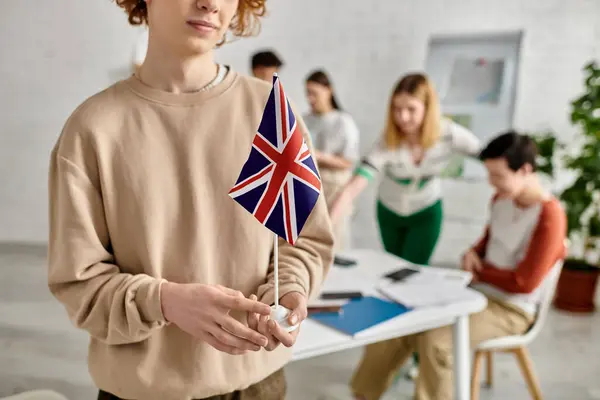 A young delegate holds a British flag during a Model United Nations conference. — Stock Photo