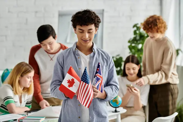 Adolescente sostiene banderas de Canadá, EE.UU., Reino Unido en Conferencia Modelo de la ONU. - foto de stock
