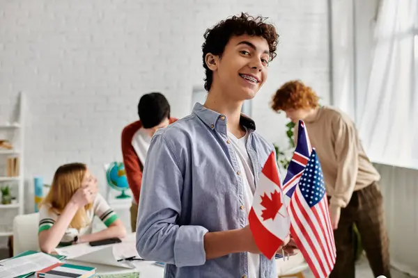 Teenage boy holds Canadian and American flags during a UN Model simulation. — Stock Photo