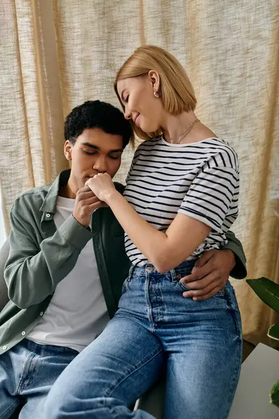 A young couple shares a tender moment in their modern apartment, showcasing the intimacy and connection they share. — Stock Photo