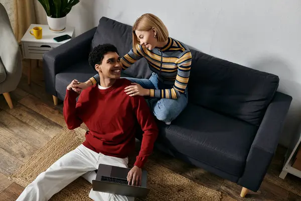 A happy multicultural couple enjoys a relaxing moment together in their modern apartment. — Stock Photo