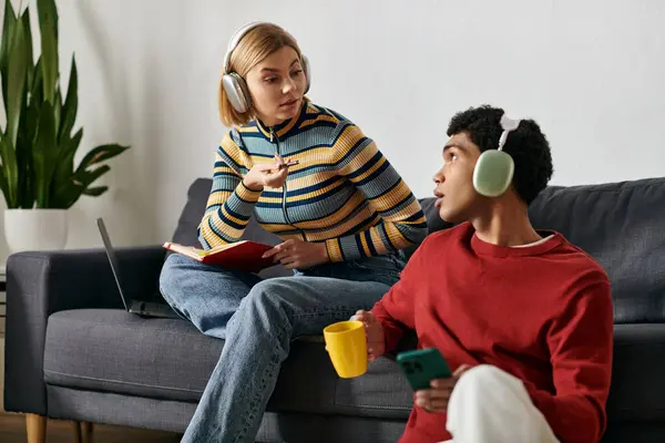A young multicultural couple relaxes in their shared apartment, enjoying a cozy afternoon together. — Stock Photo