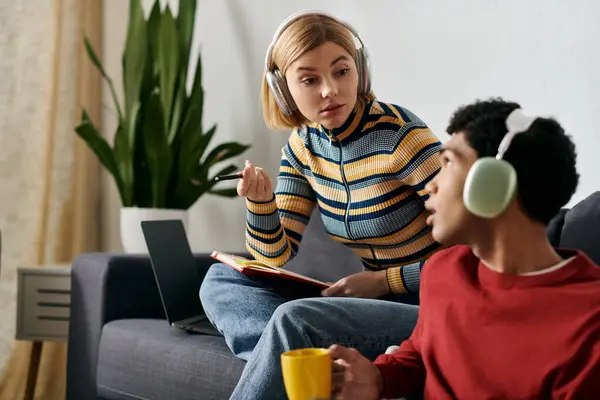 A multicultural couple enjoys a casual conversation in their modern apartment. — Stock Photo
