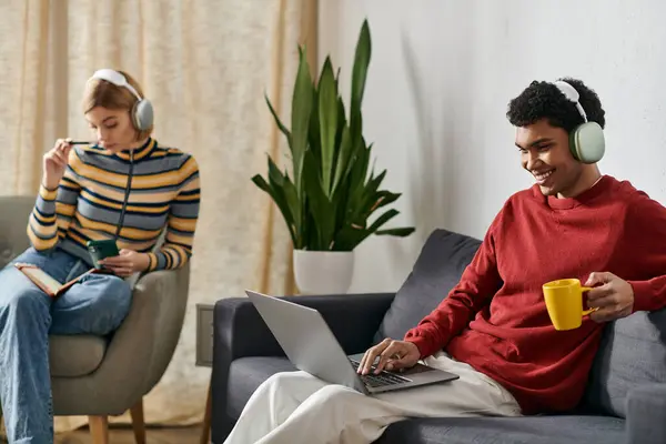 A happy multicultural couple spends a relaxing afternoon together in a modern apartment. — Stock Photo