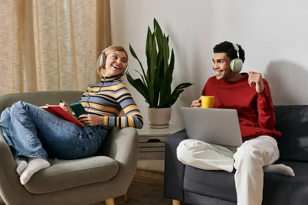 A multicultural couple relaxes in a modern apartment, enjoying each others company. — Stock Photo