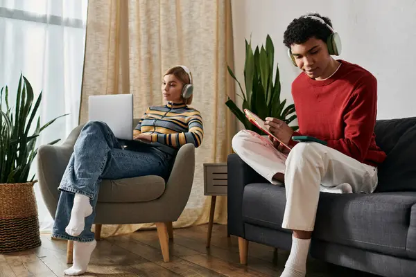A happy multicultural couple relaxes in a modern apartment, enjoying quality time together. — Stock Photo