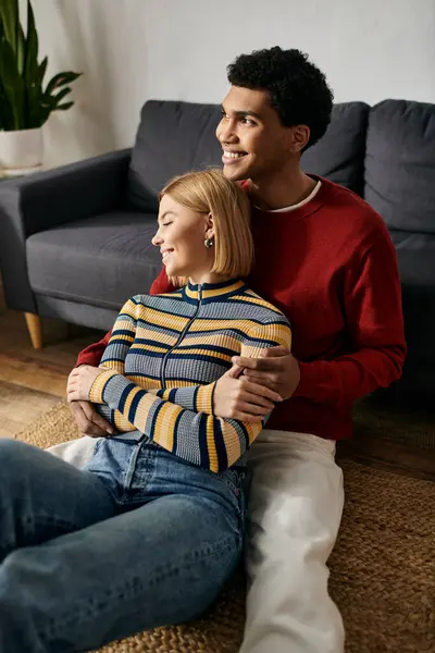 A happy multicultural couple enjoys a moment of intimacy and love in their modern apartment. — Stock Photo
