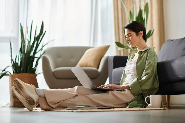 A woman works on her laptop from the comfort of her home. — Stock Photo
